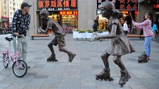 Девушка фотографируется у скульптурной группы на одной из улиц Маньчжурии Девушка фотографируется у скульптурной группы на одной из улиц Маньчжурии