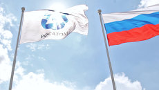 Флаги организации Росатом и России. Архивное фото Флаги организации Росатом и России. Архивное фото