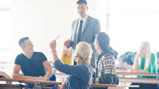 Преподаватель ведет занятие в классе. Архивное фото Преподаватель ведет занятие в классе. Архивное фото