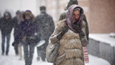 Прохожие на одной из улиц Москвы во время снегопада Прохожие на одной из улиц Москвы во время снегопада