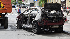 Взорванный автомобиль на перекрестке улиц Богдана Хмельницкого и Ивана Франко, в котором погиб журналист Павел Шеремет. Архивное фото Взорванный автомобиль на перекрестке улиц Богдана Хмельницкого и Ивана Франко, в котором погиб журналист Павел Шеремет. Архивное фото
