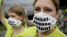 Протестующие в масках с надписью Kill diesel emissions в Берлине. Архивное фото Протестующие в масках с надписью Kill diesel emissions в Берлине. Архивное фото