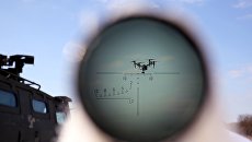 БПЛА, наблюдаемый через оптический прицел. Архивное фото БПЛА, наблюдаемый через оптический прицел. Архивное фото