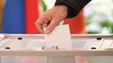 Мужчина голосует на выборах президента Российской Федерации на избирательном участке Мужчина голосует на выборах президента Российской Федерации на избирательном участке