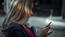 Девушка со смартфоном. Архивное фото Девушка со смартфоном. Архивное фото